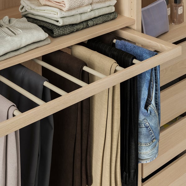 Organized pants hanger in wardrobe, displaying several pairs neatly.