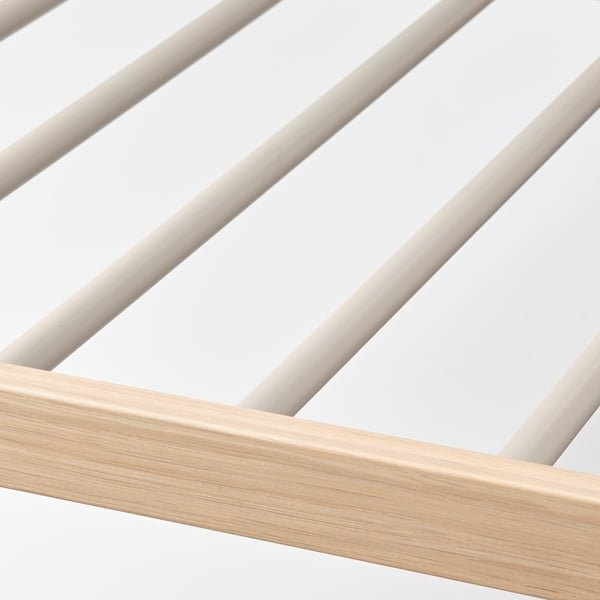 Close-up of sturdy, wood-framed trouser hanger with smooth, sliding metal bars.