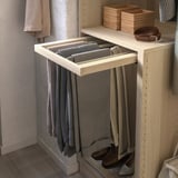KOMPLEMENT trouser hanger holds grey pants in light wood shelf.
