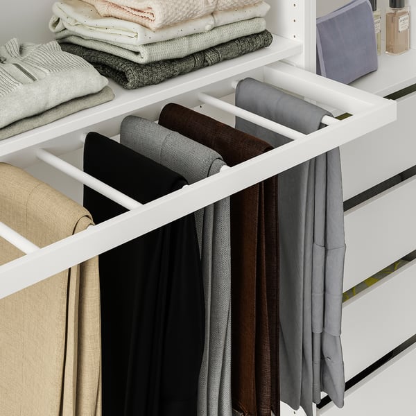 Organized wardrobe with pull-out trouser hanger holding multiple pants neatly.
