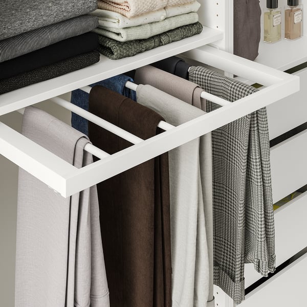 White wardrobe with pull-out trouser hanger holding multiple pairs of jeans and trousers.
