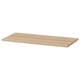 A flat light brown wooden shelf named KOMPLEMENT. Its rectangular with smooth edges and a simple design.