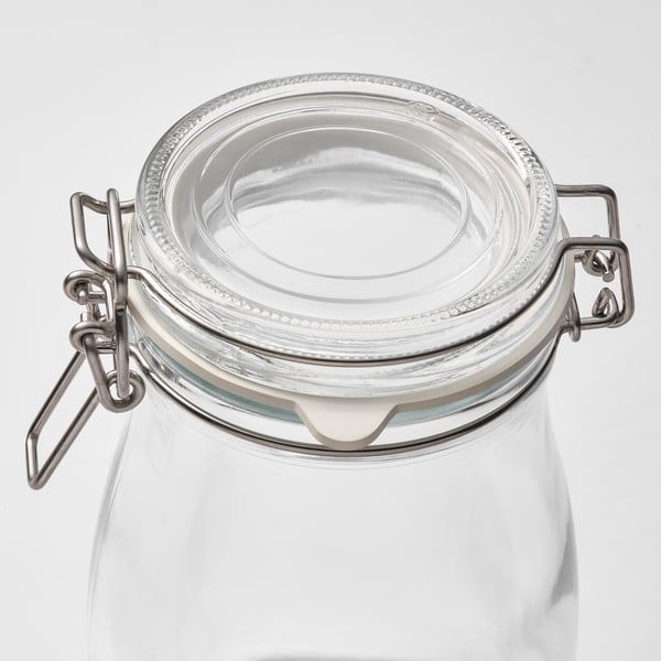 Clear glass jar with metal clamps and rubber seal, ideal for food storage.