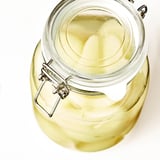 Glass jar with airtight lid, ideal for preserving food and beverages. Transparent, easy to clean.
