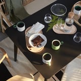 Table setting with chocolate, cups, and blanket.