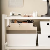 KUGGIS desk organizer: 2-tier white plastic, fits small items, files, laptop. Smaller than books, larger than drawer.