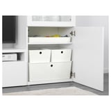 White storage unit with three compartments, two covered boxes, and a slot for gaming and art accessories. Kids toys seen inside.