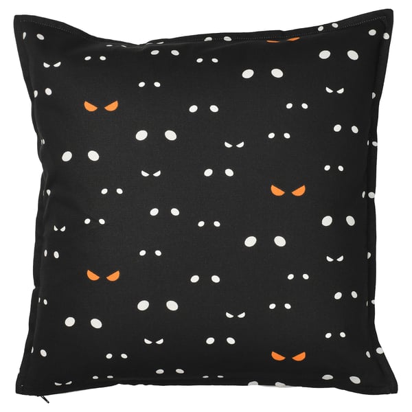 Halloween-themed black cat cushion cover, white and orange cat eyes on dark fabric. Square shape, cotton material.