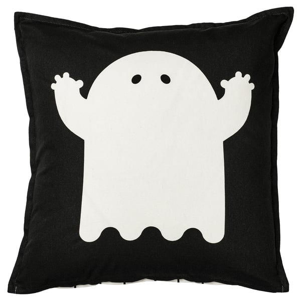 Halloween-themed pillow, black with white ghost design, square shape, cotton material.