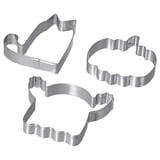 Three stainless steel cookie cutters in shapes of a house, a cloud, and an abstract design. Silver, used for making fun-shaped cookies or pastries.