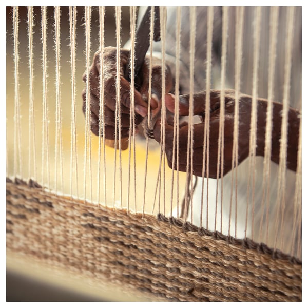 Artisan weaving rug. Natural beige wool, cotton. Hand-knotted, braided fringing. Geometric sand dune pattern.