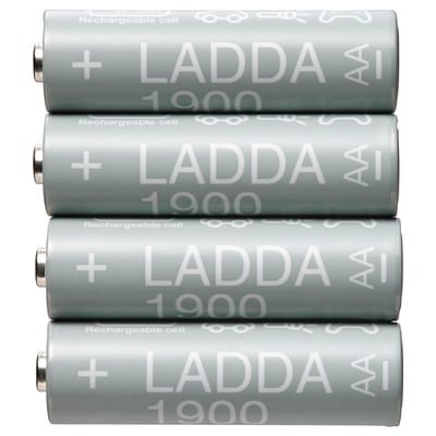 Four grey cylindrical LADDA rechargeable batteries, stacked neatly, displaying white text with + and 1900.