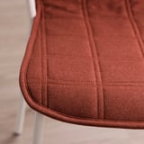 Close-up of a well-crafted, reddish-brown chair cushion with neat stitching.