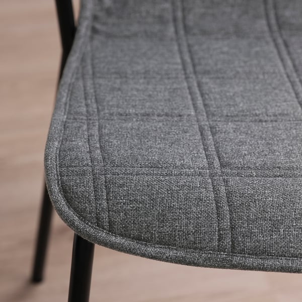 Close-up of modern, grey conference chair, highlighting smooth texture and robust stitching.