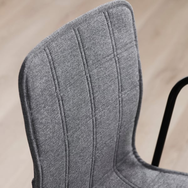 Close-up of upholstered chair back, showcasing quality stitching and dense fabric.