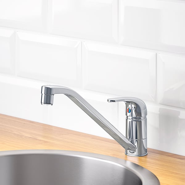 Chrome tap on wooden counter, over steel sink, efficient & durable, swivel spout.