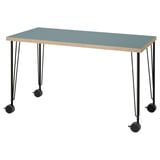 A LAGKAPTEN desk with a blue top and wooden edges, supported by black metal legs with wheels.