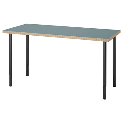 A LAGKAPTEN desk in blue with a honeycomb-patterned edge. It has adjustable black metal legs.