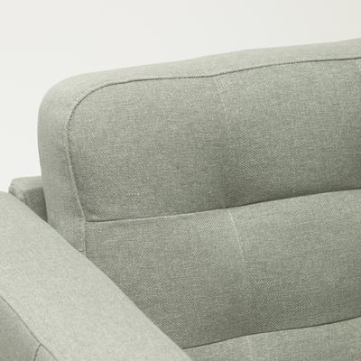 A modern upholstered sofa, soft fabric, neatly stitched cushions, padded for comfort.