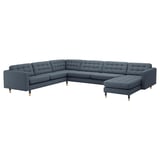 A blue, modern l-shaped sectional sofa with wooden legs, tufted seat and back cushions, and a chaise lounge.