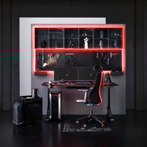 Futuristic gaming setup with red led lights, black chair, desk, and shelves displaying collectibles.