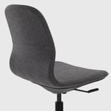 Dark grey office chair with height-adjustable seat, lumbar support, and tilt function. Tilt mechanism visible.
