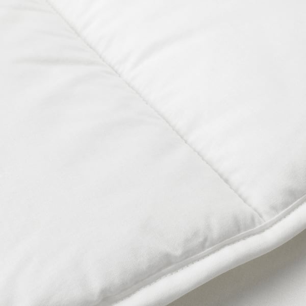 Close-up of a white duvet showcasing its smooth fabric and stitching, highlighting its soft and lightweight quality.