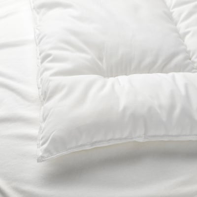 A close-up of a white pillow, showcasing its soft, smooth fabric and supportive stuffing, emphasizing its high-quality materials.