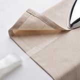 Folded beige curtain, hooks, and hemming tape shown.
