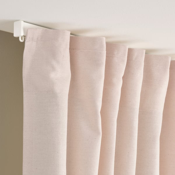 Pinkish drapes with white hooks; adjusts privacy, daylight.