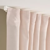 Pinkish drapes with white hooks; adjusts privacy, daylight.