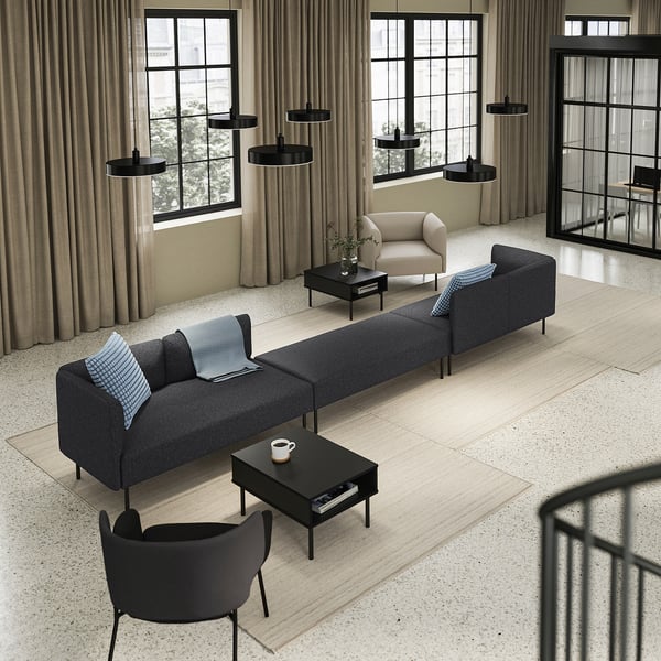 Modern living room with large windows, LILLEHEM sofa, black coffee table & lights.