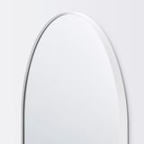 Arch-shaped mirror with sleek, white frame; reflective surface pristine, corners rounded; minimalist, elegant design.