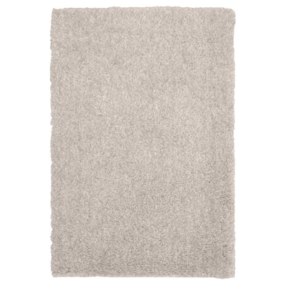 Soft beige LINDKNUD rug. Rectangular, plush texture from recycled polyester. Ideal for bedrooms.
