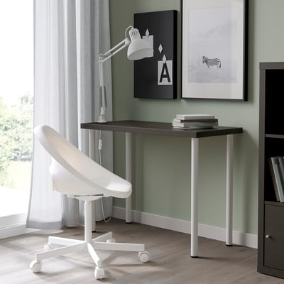 Modern minimalist desk setup with white LINNMON table, white chair, lamp, and wall art.