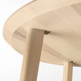 Close-up of sturdy, natural wood table. Smooth, durable finish. Solid birch legs and ash veneer top.