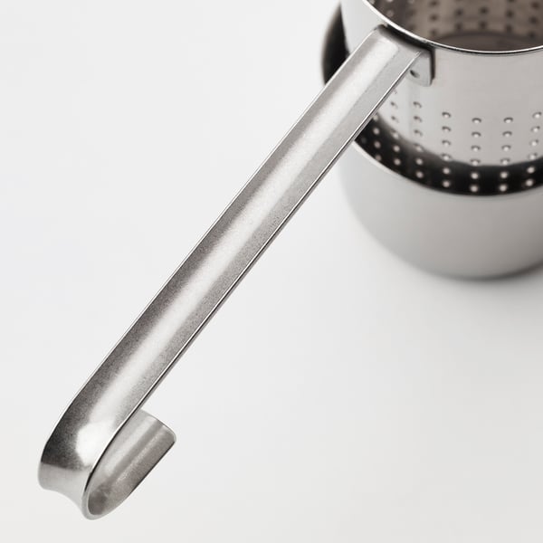 Close-up of sleek stainless steel tea infuser, showcasing its sturdy handle.