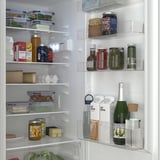 Fridge with adjustable shelves, organized food items, and led light inside, showing clean and neat storage.