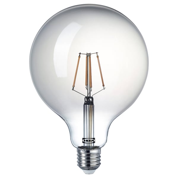 The ikea LUNNOM bulb a warm, 2200k glow with a spiral filament inside smoke-colored glass, creating a cozy ambiance.