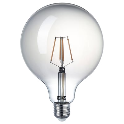 The ikea LUNNOM bulb a warm, 2200k glow with a spiral filament inside smoke-colored glass, creating a cozy ambiance.