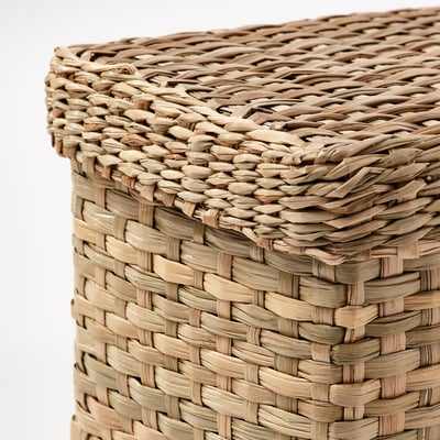 Two handwoven seagrass storage baskets. One is larger, the other smaller, both rectangular with lid. The natural color and texture give a rustic look.