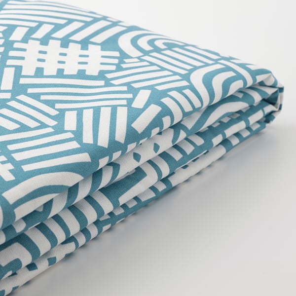 Folded turquoise and white patterned fabric, showcasing its soft texture and intricate design.