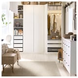 Modern bedroom with white LYDERSHOLM rug, light wood floors, built-in wardrobe, drawers, and desk with chair.