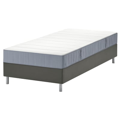 A gray lyngor mattress on a bed base with metallic legs.