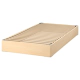 A light wood-coloured LYNGÖR bed base with slats for mattress support.