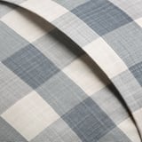 Close-up of checkered cushion cover with folded edge, displaying a simple, settle design. Embroidered hearts not visible.