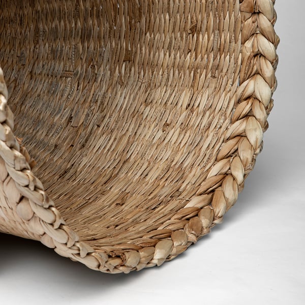Close-up of intricately woven banana fiber basket, showcasing natural texture and craftsmanship.