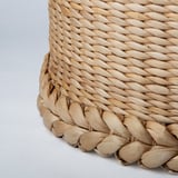 Handwoven lamp shade with intricate braiding, showcasing natural banana fibers, craftsmanship, and texture.
