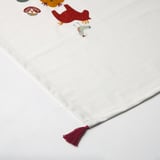 White table runner with colorful embroidered designs, burgundy tassels, high-quality cotton.