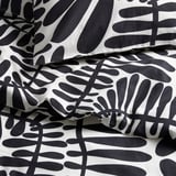 Black and white leaf-patterned bedding, crisp and stylish. 100% cotton blend, bold natural design.
